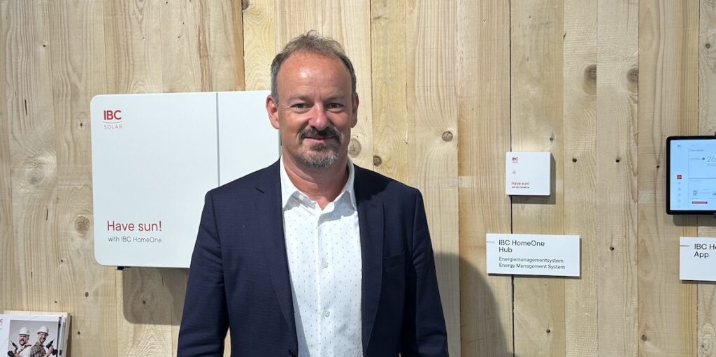Dirk Haft, Geschäftsführer von IBC Solar, auf der Intersolar 2024 neben dem Komplettpaket-Portfolio "HomeOne".